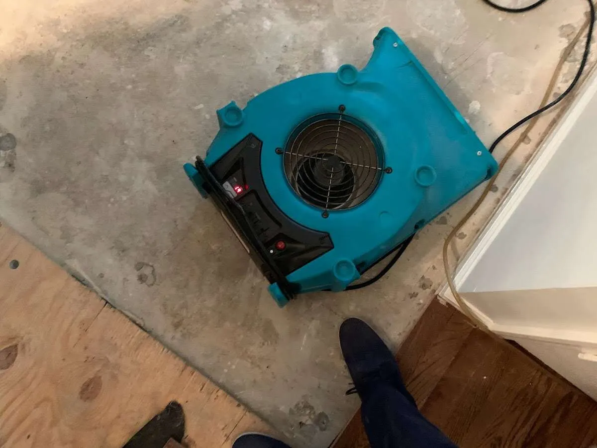 Air mover drying subfloor during Leak Detection & Repair in Jefferson City